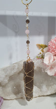Load image into Gallery viewer, WAND OF STRENGTH" Handcrafted Smoky Quartz Tower Point Stone Gold Crystal Energy Enhancer© Hanger Ornament Suncatcher 

Inspires GROUNDING | LOVE | STABILITY

Gorgeous Smoky Quartz crystal tower beaded with Smoky Quartz, Rose Quartz and Herkimer Diamond.  Wire wrapped in gold
