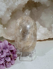 Load image into Gallery viewer, Lovely Moonstone Palm Stone Crystal Carving on plastic stand. Inspires Divine Connection and Clarity
