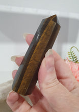 Load image into Gallery viewer, SECONDS STOCK - Tigers Eye Crystal Point Tower Stone

THIS POINT IS A LITTLE WOBBLY

INSPIRES STRENGTH AND SUCCESS

Tigers Eye Tower Crystal Stone. Discounted as this is wobbly.  
