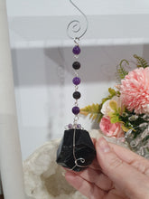 Load image into Gallery viewer, WITCHES AMULET - Handcrafted Obsidian Stone Crystal Energy Enhancer© / Hanger / Ornament / Suncatcher 

INSPIRES PROTECTION AND INTUITION

Gorgeous Obsidian raw crystal stone beaded with Black Obsidian and Amethyst. Wire wrapped in silver
