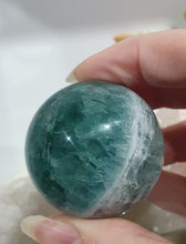 Load image into Gallery viewer, Fluorite Sphere Crystal Carving Stone on Silver Stand

Inspires CONCENTRATION AND STABILITY

Lovely Fluorite Crystal Sphere on silver stand.  super pretty.  Feather fluorite. Amazing pattern.  
