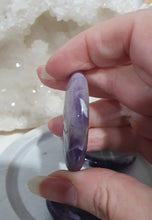 Load image into Gallery viewer, Worry Stone" Amethyst Crystal Carving Stone.

INSPIRES INTUITION AND SPIRITUALITY

What is a worry Stone? Perfectly shaped for your thumb, this crystal worry stone connects you to positive energy. Rubbing its smooth surface allows it to act as a powerful vessel for emotional release from anxiety and stress.

Lovely Amethyst crystal worry stone crystal carving.  Pop in your bag and keep with you to alleviate stress. Intuitively ( Randomly) chosen.

