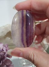 Load image into Gallery viewer, Fluorite Crystal Palm Stone palmstone on plastic stand. 

Inspires CONCENTRATION AND STABILITY

Lovely Fluorite Crystal Palm stone on plastic stand. So pretty.  
