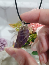 Load image into Gallery viewer, "WING OF AN ANGEL" Amethyst Angel Wing Crystal Stone Pendant wire wrapped Silver .

Inspires Divine Connection and Intuition.

Angel Wings symbolise love, protection, purity and freedom. Connections to the Angels and divine realm.

Beautiful handcrafted Amethyst Angel Wing Crystal Carving Pendant in silver non tarnish wire. Comes with a cord necklace.
