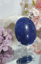 Load image into Gallery viewer, Lapis Lazuli Crystal Palm Stone palm stone on plastic stand. 

INSPIRES HARMONY, WISDOM &amp; PSYCHIC PROTECTION

Lovely Lapis Lazuli Crystal Palm stone with pyrite inclusions on plastic stand. So pretty.  


