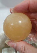 Load image into Gallery viewer, Honey Calcite Sphere Crystal Carving on silver stand

INSPIRES SELF WORTH AND CONFIDENCE

lovely Honey Calcite sphere on ornate silver stand
