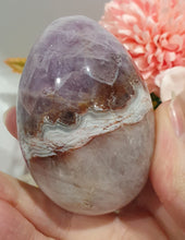Load image into Gallery viewer, Amethyst Agate Egg Crystal Carving Stone on Stand

Inspires intuition and Emotional Well Being

Beautiful Polished Amethyst Agate Egg Crystal Carving on plastic stand. Has natural divits formations.
