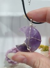Load image into Gallery viewer, Amethyst Moon Crystal Pendant Wire Wrapped Silver Stone with black cord chain

INSPIRES INTUITION AND SPIRITUALITY

Beautiful Amethyst Moon Crystal Carving Wire Wrapper in Silver non tarnish wire. Accompanied by a black cord necklace

