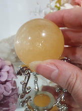 Load image into Gallery viewer, Honey Calcite Sphere Crystal Carving on silver stand

INSPIRES SELF WORTH AND CONFIDENCE

lovely Honey Calcite sphere on ornate silver stand
