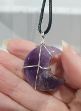 Load image into Gallery viewer, Amethyst Moon Crystal Pendant Wire Wrapped Silver Stone with black cord chain

INSPIRES INTUITION AND SPIRITUALITY

Beautiful Amethyst Moon Crystal Carving Wire Wrapper in Silver non tarnish wire. Accompanied by a black cord necklace
