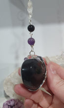 Load image into Gallery viewer, THE WITCHES HEART" Handcrafted Obsidian Heart Crystal Carving Stone Silver Crystal Energy Enhancer© Hanger Ornament Suncatcher 

INSPIRES MAGIC, INTUITION AND PROTECTION

Gorgeous Obsidian heart crystal carving stone beaded with Black Obsidian, Amethyst and Herkimer Diamonds. Wire wrapped in silver
