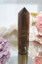 Load image into Gallery viewer, SECONDS STOCK - Tigers Eye Crystal Point Tower Stone

THIS POINT IS A LITTLE WOBBLY

INSPIRES STRENGTH AND SUCCESS

Tigers Eye Tower Crystal Stone. Discounted as this is wobbly.  
