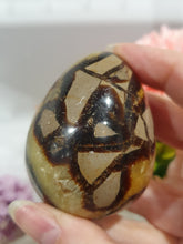 Load image into Gallery viewer, Septarian (Dragon Stone) Egg Crystal Carving Stone on Stand.

Grounds &amp; Nurtures

Beautiful Polished Septarian Egg Crystal Carving on plastic stand. Has natural divits formations. Madagascar sourced.

Known as the Dragon Stone. Formed 70 million years ago from volcanic mud and sea life. These polished egg shaped feature cracked patterns of yellow Calcite, brown Aragonite and grey Limestone.The egg shape symbolises new beginnings, the "unfolding of energy from within,".
