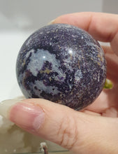 Load image into Gallery viewer, Purple Sphalerite Sphere Crystal Carving on Silver Stand.

Inspires Spirituality &amp; Strength

Stunning Purple Sphalerite Crystal Sphere on Silver Sand. This has a gorgeous quartz vein and pocket of druzy. 
