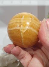 Load image into Gallery viewer, Orange Calcite Sphere Crystal Carving Stone on Silver Stand. This has a crack in it

Inspires JOY AND SELF CONFIDENCE

Lovely Orange Calcite Crystal Sphere on silver stand.  Discounted as has a crack. still a gorgeous sphere.  
