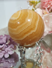 Load image into Gallery viewer, Orange Calcite Sphere Crystal Carving Stone on Silver Stand. This has a crack in it

Inspires JOY AND SELF CONFIDENCE

Lovely Orange Calcite Crystal Sphere on silver stand.  Discounted as has a crack. still a gorgeous sphere.  
