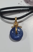 Load image into Gallery viewer, Stunning Blue Kyanite crystal stone donut crystal carving wire wrapped in non tarnish gold wire.  Come with a black cork necklace.
