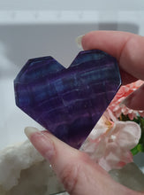 Load image into Gallery viewer, Heart Fluorite Crystal Carving Stone on plastic Stand

Inspires CONCENTRATION AND STABILITY

Lovely Fluorite Heart with blue colouring on plastic stand.  super pretty.   
