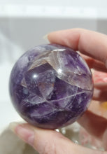 Load image into Gallery viewer, Amethyst Chevron Sphere Crystal Carving Stone on Gold Stand

Inspires INTUITION AND SPIRITUALITY

Lovely Amethyst Crystal Sphere on gold stand.  Gorgeous colouring.  
