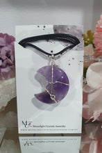 Load image into Gallery viewer, Amethyst Moon Crystal Pendant Wire Wrapped Silver Stone with black cord chain

INSPIRES INTUITION AND SPIRITUALITY

Beautiful Amethyst Moon Crystal Carving Wire Wrapper in Silver non tarnish wire. Accompanied by a black cord necklace
