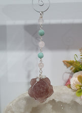 Load image into Gallery viewer, "THE BLUSHING ROSE" Strawberry Quartz Rose Carving silver Crystal Energy Enhancer© Hanger Ornament Suncatcher.

HAPPINESS / LOVE / HARMONY

"THE BLUSHING ROSE - Like the petals of a rose unfolding, The Blushing Rose encourages us to embrace self-love, joy and the beauty within."

Gorgeous Strawberry Quartz Rose Crystal Carving beaded with Ice Pink Malaysian Jade, Rose Quartz, Amazonite and Quartz. Wire wrapped in silver
