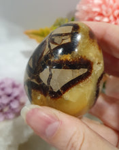 Load image into Gallery viewer, Septarian (Dragon Stone) Egg Crystal Carving Stone on Stand.

Grounds &amp; Nurtures

Beautiful Polished Septarian Egg Crystal Carving on plastic stand. Has natural divits formations. Madagascar sourced.

Known as the Dragon Stone. Formed 70 million years ago from volcanic mud and sea life. These polished egg shaped feature cracked patterns of yellow Calcite, brown Aragonite and grey Limestone.The egg shape symbolises new beginnings, the "unfolding of energy from within,".
