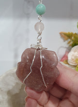 Load image into Gallery viewer, "THE BLUSHING ROSE" Strawberry Quartz Rose Carving silver Crystal Energy Enhancer© Hanger Ornament Suncatcher.

HAPPINESS / LOVE / HARMONY

"THE BLUSHING ROSE - Like the petals of a rose unfolding, The Blushing Rose encourages us to embrace self-love, joy and the beauty within."

Gorgeous Strawberry Quartz Rose Crystal Carving beaded with Ice Pink Malaysian Jade, Rose Quartz, Amazonite and Quartz. Wire wrapped in silver
