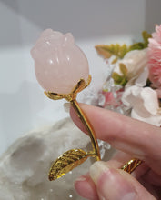 Load image into Gallery viewer, Rose Flower Rose Quartz Crystal Carving with gold stem.

Promotes Unconditional Love and Harmony

Beautiful Rose Quartz Flower / Rose Crystal Carving with gold stem and leaves.    
