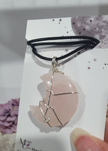 Load image into Gallery viewer, Rose Quartz Moon Crystal Pendant Wire Wrapped Silver Stone with black cord chain

INSPIRES UNCONDITIONAL LOVE &amp; HARMONY

Beautiful Rose Quartz Moon Crystal Carving Wire Wrapper in Silver non tarnish wire. Accompanied by a black cord necklace


