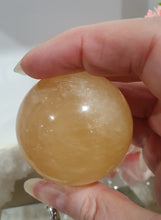 Load image into Gallery viewer, Honey Calcite Sphere Crystal Carving on silver stand

INSPIRES SELF WORTH AND CONFIDENCE

lovely Honey Calcite sphere on ornate silver stand
