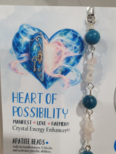 Load image into Gallery viewer, HEART OF POSSIBILITY" Handcrafted Apatite Heart Crystal Carving Silver Crystal Energy Enhancer© / Hanger / Ornament / Suncatcher 

MANIFEST | LOVE | HARMONY

Gorgeous Apatite heart crystal carving beaded with Apatite, Rose Quartz &amp; Quartz.  Wire wrapped in silver
 
