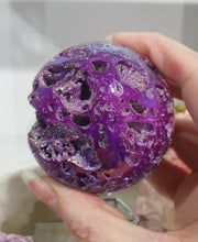 Load image into Gallery viewer, Pink Titanium Aura Sphalerite Sphere Crystal Carving on Silver Stand.

PROMOTES PSYCHIC DEVELOPMENT AND UPLIFTS

Absolutely Stunning Pink Titanium Aura Sphalerite Crystal Sphere on Silver Sand. The druzy on this in insane!. 
