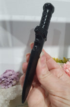 Load image into Gallery viewer, Beautiful polished Black Obsidian Athame (Dagger) Crystal Carving Stone.  

INSPIRES PROTECTION AND BALANCE

An Athame is a ceremonial knife used in spiritual rituals to direct energy, cast circles, and represent the element of fire or air, but it is typically not used for physical cutting.

Stunning polished Black Obsidain Athame Dagger Crystal Carving.


