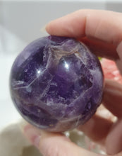 Load image into Gallery viewer, Amethyst Chevron Sphere Crystal Carving Stone on Gold Stand

Inspires INTUITION AND SPIRITUALITY

Lovely Amethyst Crystal Sphere on gold stand.  Gorgeous colouring.  
