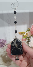Load image into Gallery viewer, LIGHT THROUGH DARKNESS" Handcrafted Black Agate Tower Crystal Carving Silver Crystal Energy Enhancer© Gemstone / Hanger / Suncatcher / Ornament 

STRENGTH | COURAGE | CLARITY

Beautiful Black Agate Tower Carving Crystal Energy Enhancer© / Sun Catcher / Ornament / Hanger beaded with Black Agate, Quartz and Herkimer Diamonds.  wired in Silver


