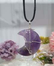 Load image into Gallery viewer, Amethyst Moon Crystal Pendant Wire Wrapped Silver Stone with black cord chain

INSPIRES INTUITION AND SPIRITUALITY

Beautiful Amethyst Moon Crystal Carving Wire Wrapper in Silver non tarnish wire. Accompanied by a black cord necklace
