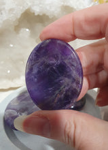 Load image into Gallery viewer, Worry Stone" Amethyst Crystal Carving Stone.

INSPIRES INTUITION AND SPIRITUALITY

What is a worry Stone? Perfectly shaped for your thumb, this crystal worry stone connects you to positive energy. Rubbing its smooth surface allows it to act as a powerful vessel for emotional release from anxiety and stress.

Lovely Amethyst crystal worry stone crystal carving.  Pop in your bag and keep with you to alleviate stress. Intuitively ( Randomly) chosen.


