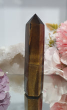 Load image into Gallery viewer, SECONDS STOCK - Tigers Eye Crystal Point Tower Stone

THIS POINT IS A LITTLE WOBBLY

INSPIRES STRENGTH AND SUCCESS

Tigers Eye Tower Crystal Stone. Discounted as this is wobbly.  
