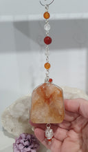 Load image into Gallery viewer, THE FIRE WITHIN" Handcrafted Fire Quartz Tower Crystal Carving Silver Crystal Energy Enhancer© Gemstone / Hanger / Suncatcher / Ornament 

STRENGTH | POWER | SPIRITUALITY

Beautiful Fire Quartz Tower Carving Crystal Energy Enhancer© / Sun Catcher / Ornament / Hanger beaded with Fire Quartz, Carnelian and Quartz.  wired in Silver
