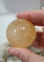 Load image into Gallery viewer, Honey Calcite Sphere Crystal Carving on silver stand

INSPIRES SELF WORTH AND CONFIDENCE

lovely Honey Calcite sphere on ornate silver stand
