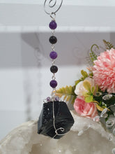 Load image into Gallery viewer, WITCHES AMULET - Handcrafted Obsidian Stone Crystal Energy Enhancer© / Hanger / Ornament / Suncatcher 

INSPIRES PROTECTION AND INTUITION

Gorgeous Obsidian raw crystal stone beaded with Black Obsidian and Amethyst. Wire wrapped in silver
