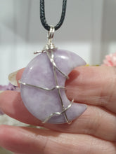 Load image into Gallery viewer, Lepidolite Moon Crystal Pendant Wire Wrapped Silver Stone with black cord chain

STONE OF TRANSITION

Beautiful Lepidolite Moon Crystal Carving Wire Wrapper in Silver non tarnish wire. Accompanied by a black cord necklace
