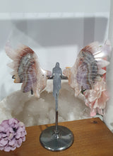 Load image into Gallery viewer, Amethyst Agate Angel Wings on stand.

Inspires Intuition and connection to the divine

Angel Wings
Symbolise love, protection, purity and freedom. Connections to the Angels and divine realm.

Beautiful Amethyst Agate Angel wings on stand.   A must for any crystal collection!

