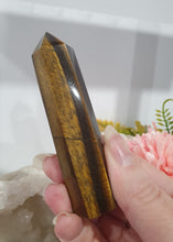 Load image into Gallery viewer, SECONDS STOCK - Tigers Eye Crystal Point Tower Stone

THIS POINT IS A LITTLE WOBBLY

INSPIRES STRENGTH AND SUCCESS

Tigers Eye Tower Crystal Stone. Discounted as this is wobbly.  
