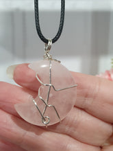 Load image into Gallery viewer, Rose Quartz Moon Crystal Pendant Wire Wrapped Silver Stone with black cord chain

INSPIRES UNCONDITIONAL LOVE &amp; HARMONY

Beautiful Rose Quartz Moon Crystal Carving Wire Wrapper in Silver non tarnish wire. Accompanied by a black cord necklace


