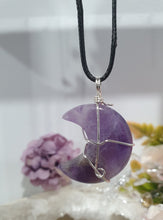 Load image into Gallery viewer, Amethyst Moon Crystal Pendant Wire Wrapped Silver Stone with black cord chain

INSPIRES INTUITION AND SPIRITUALITY

Beautiful Amethyst Moon Crystal Carving Wire Wrapper in Silver non tarnish wire. Accompanied by a black cord necklace
