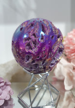 Load image into Gallery viewer, Pink Titanium Aura Sphalerite Sphere Crystal Carving on Silver Stand.

PROMOTES PSYCHIC DEVELOPMENT AND UPLIFTS

Absolutely Stunning Pink Titanium Aura Sphalerite Crystal Sphere on Silver Sand. The druzy on this in insane!. 
