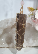 Load image into Gallery viewer, WAND OF STRENGTH" Handcrafted Smoky Quartz Tower Point Stone Gold Crystal Energy Enhancer© Hanger Ornament Suncatcher 

Inspires GROUNDING | LOVE | STABILITY

Gorgeous Smoky Quartz crystal tower beaded with Smoky Quartz, Rose Quartz and Herkimer Diamond.  Wire wrapped in gold
