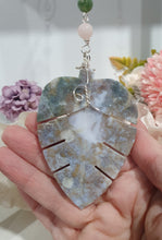 Load image into Gallery viewer, LEAF OF RENEWAL - Handcrafted Moss Agate Leaf silver Crystal Energy Enhancer© / Hanger / Ornament / Suncatcher 

SPIRITUAL GROWTH | LOVE | BALANCE

Gorgeous Moss Agate leaf crystal carving beaded with Rose Quartz &amp; Moss Agate. Wire wrapped in silver

Genuine Crystals. no plastic or glass. Ensuring energy flow throughout the enhancer. 



