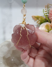 Load image into Gallery viewer, "THE BLUSHING ROSE" Strawberry Quartz Rose Carving gold Crystal Energy Enhancer© Hanger Ornament Suncatcher.

HAPPINESS / LOVE / HARMONY

"THE BLUSHING ROSE - Like the petals of a rose unfolding, The Blushing Rose encourages us to embrace self-love, joy and the beauty within."

Gorgeous Strawberry Quartz Rose Crystal Carving beaded with Ice Pink Malaysian Jade, Rose Quartz, Amazonite and Quartz. Wire wrapped in gold
